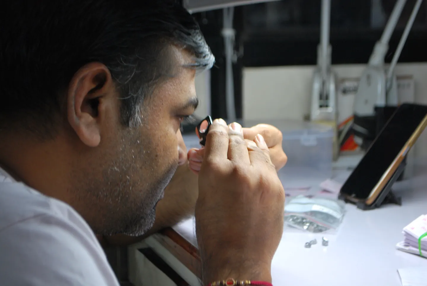 Close view of a craftsperson inspecting a stone