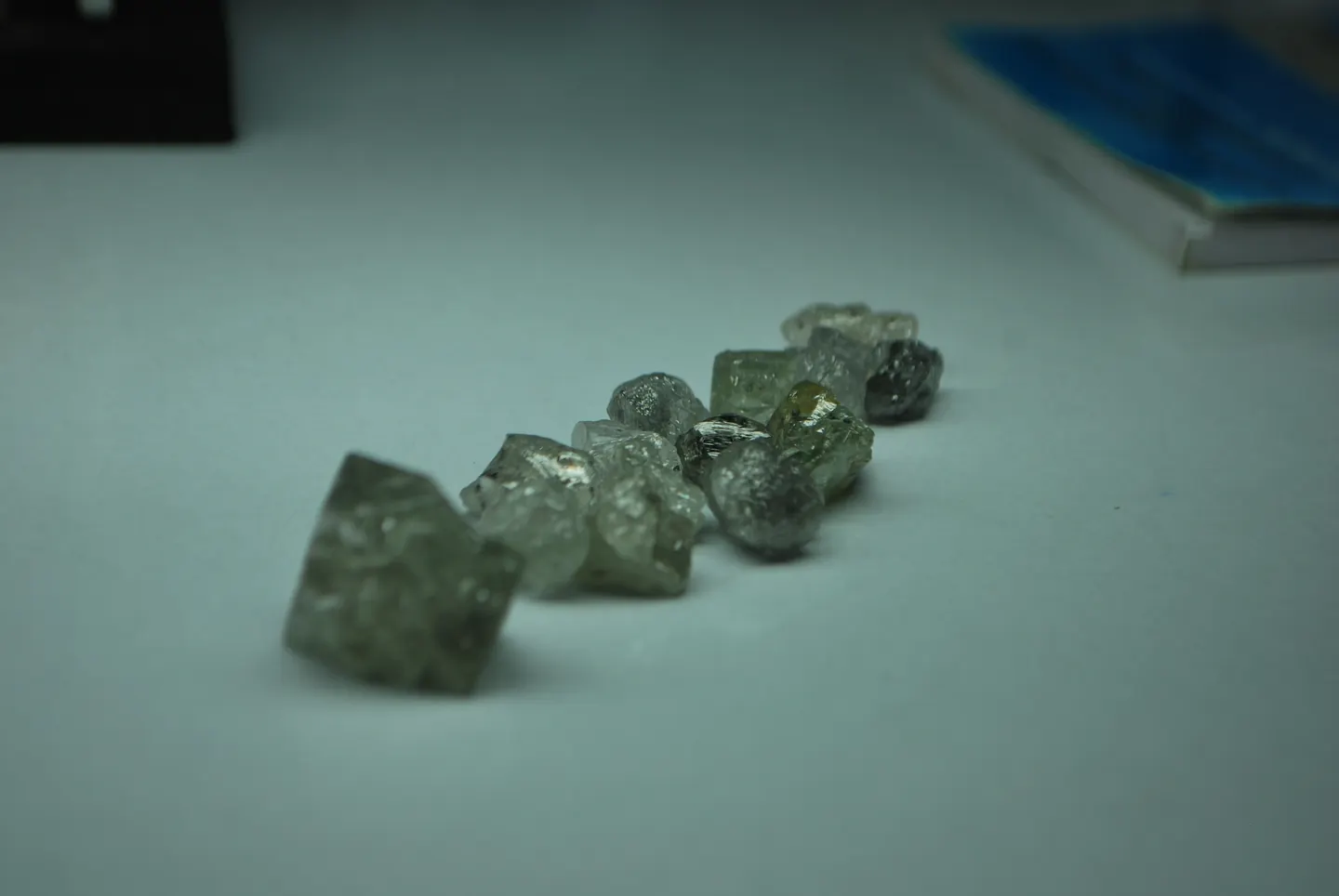 Several rough stones on a pale inspection surface